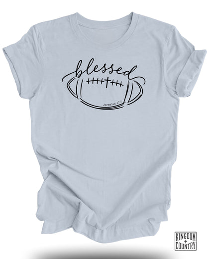 Light blue t-shirt with black graphic of a football, cross, and "blessed" text.