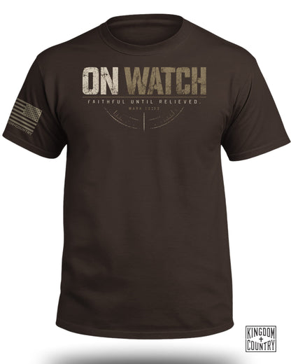 Brown t-shirt with "ON WATCH" text, American flag, and "Kingdom+Country" logo.