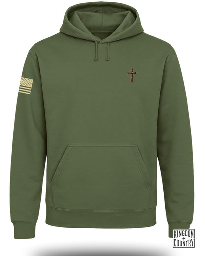 Olive green hoodie with embroidered cross and American flag patch.