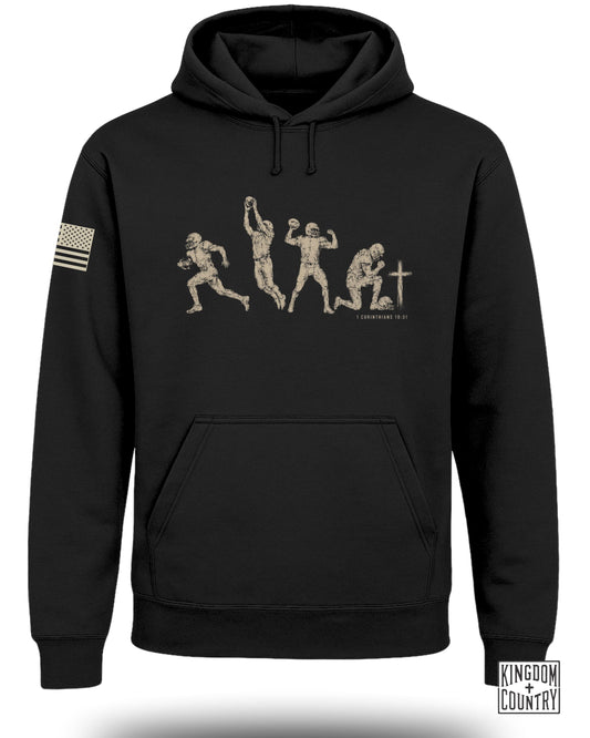 Black hoodie with graphic of football player evolution and 1 Corinthians 10:31.