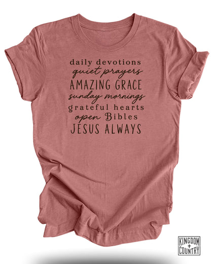 Rose t-shirt with text: daily devotions, quiet prayers, AMAZING GRACE, sunday mornings, grateful hearts, open Bibles, JESUS ALWAYS.