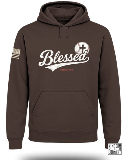 Brown pullover hoodie featuring a front pocket, a white distressed "Blessed" graphic with a baseball, and an American flag patch on the sleeve.