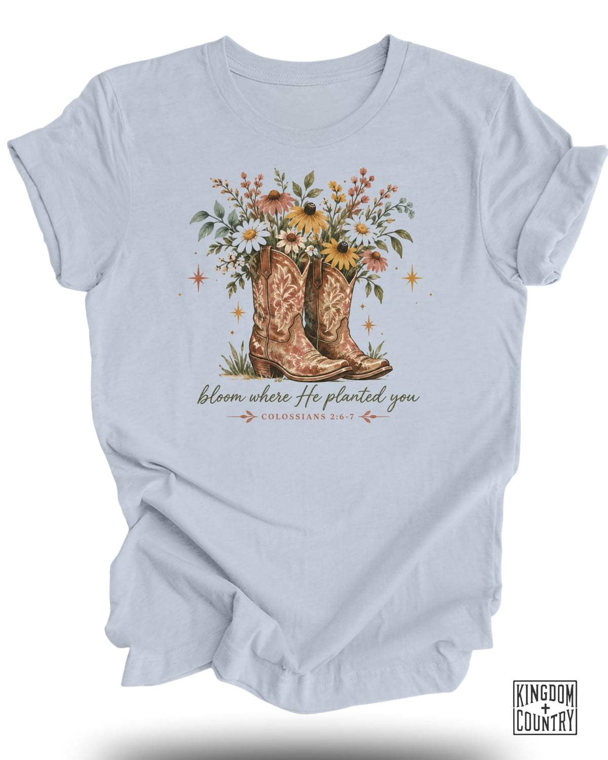 Light blue t-shirt with cowboy boots and floral arrangement graphic and text.