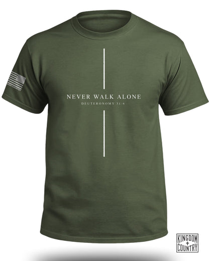 Olive t-shirt with "NEVER WALK ALONE DEUTERONOMY 31:6" print and US flag graphic.