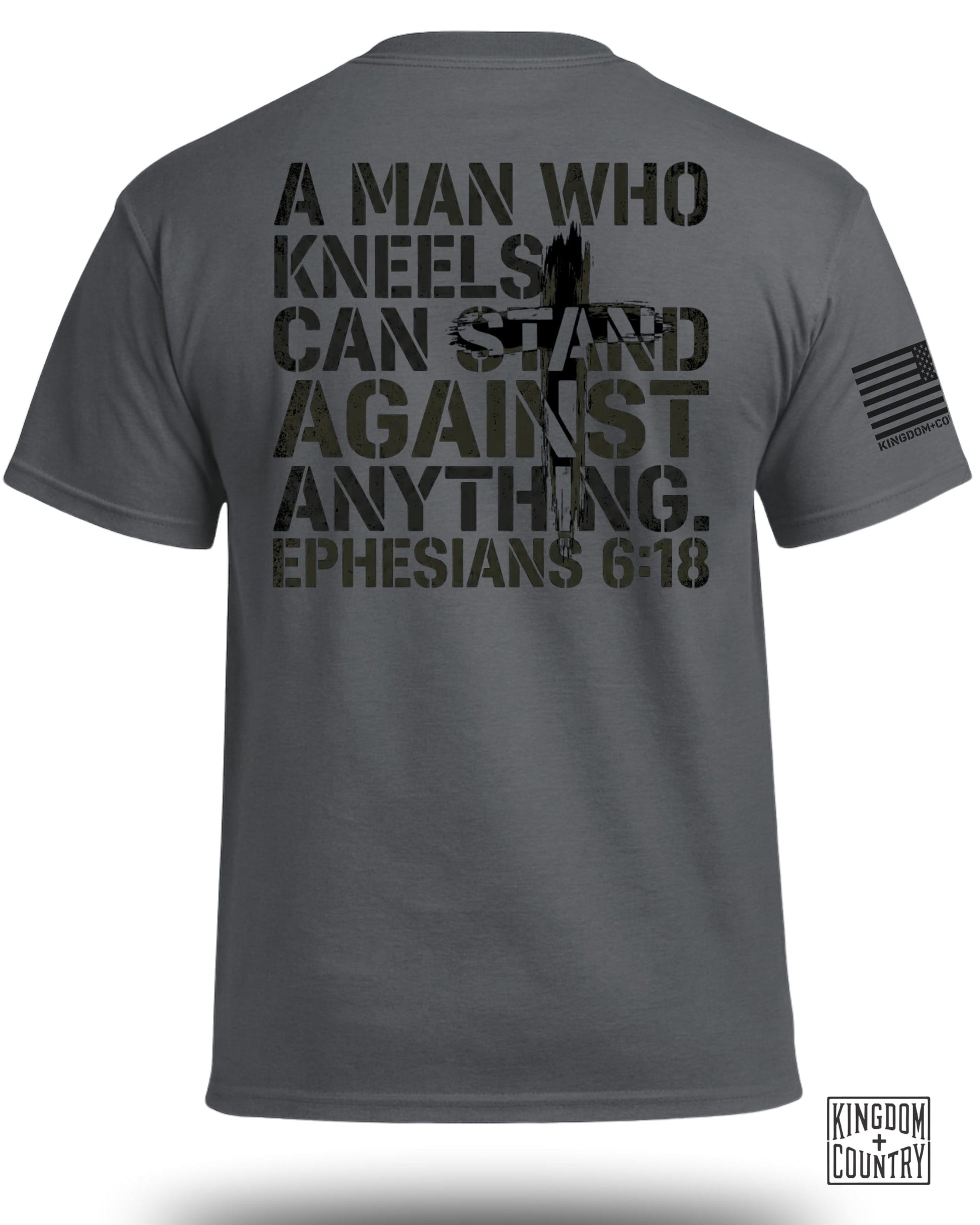 Dark grey t-shirt with "A man who kneels can stand against anything. Ephesians 6:18" text.