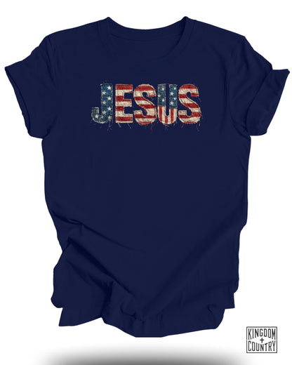 Navy t-shirt with "JESUS" in distressed American flag print.