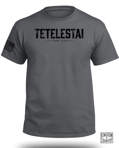 Grey t-shirt with "TETELSTAI JOHN 19:30" text and American flag detail.