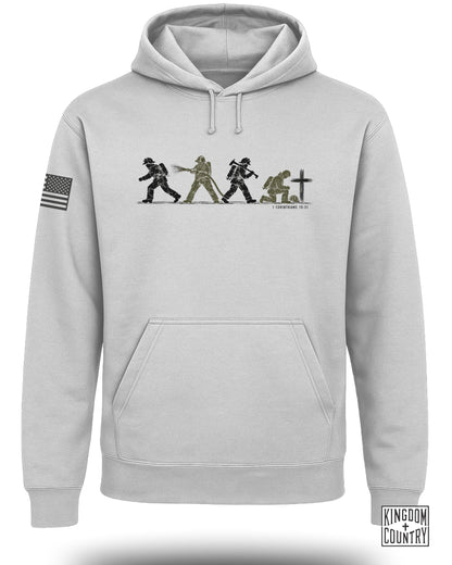 Light grey pullover hoodie with a front graphic of firefighters and a cross, plus a US flag sleeve patch.