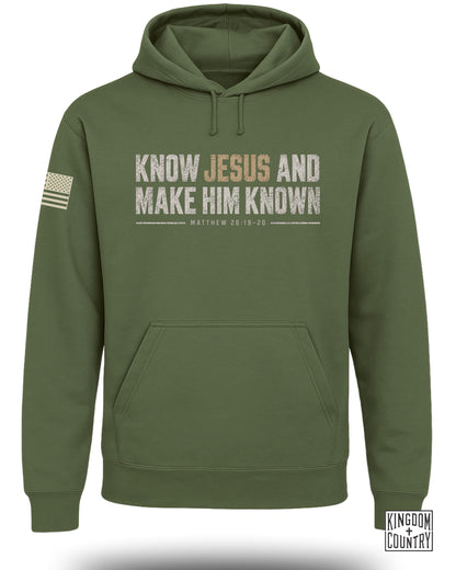 Olive green hoodie with "Know Jesus and Make Him Known" text and American flag on sleeve.