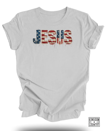 White t-shirt with distressed American flag "JESUS" graphic.