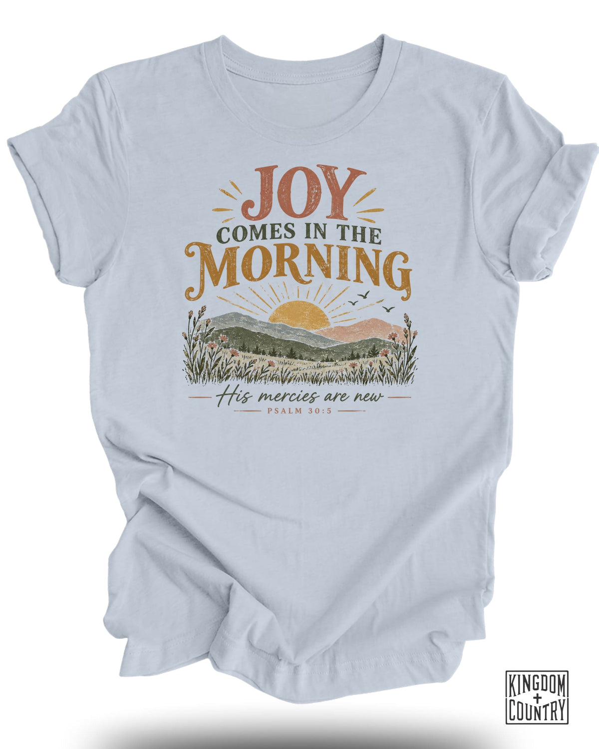 Light blue t-shirt with "Joy Comes in the Morning" and "His Mercies are New" text and sunrise scene.