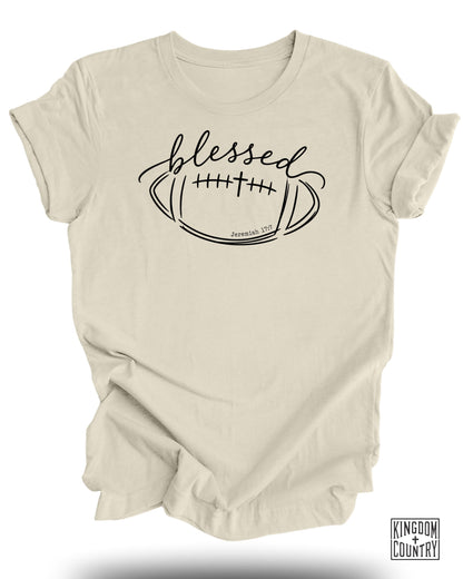 Cream t-shirt with "blessed" and football design with "Jeremiah 17:7".