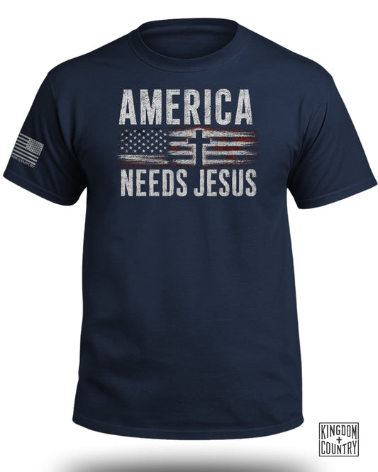 Navy t-shirt with American flag and "AMERICA NEEDS JESUS" text.